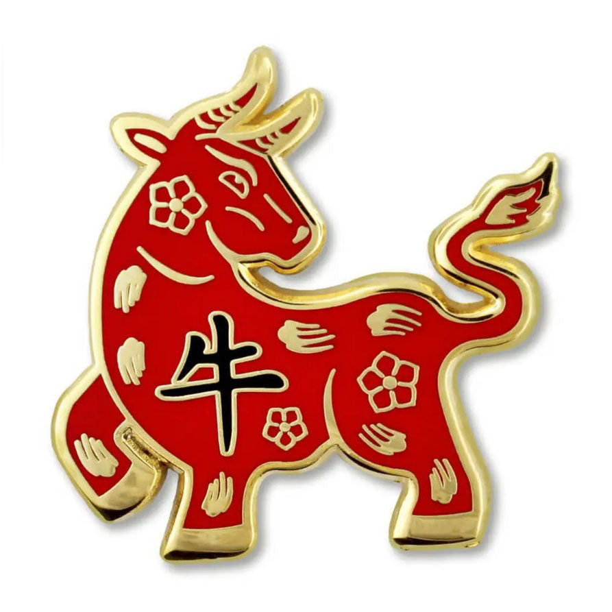 Red and gold Ox Zodiac pin with Chinese characters on a white background