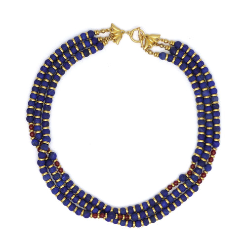 Triple strand lapis bead necklace with gold colored and carnelian accents. Shown with clasp closed on a white background.