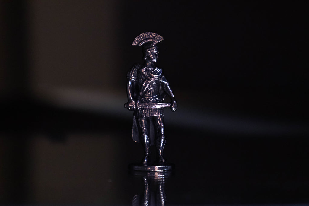 Praetorian figurine with black and purple background. 