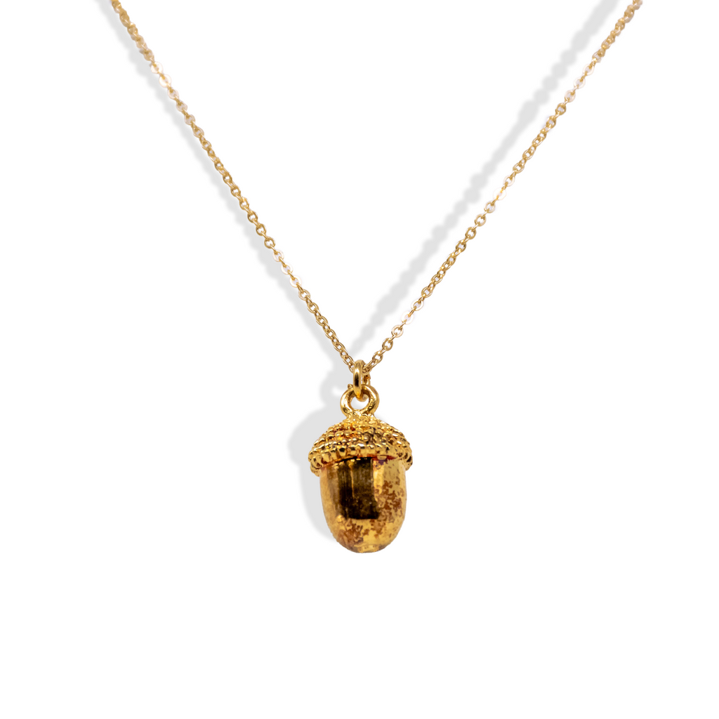 Gold dainty acorn necklace on gold chain.