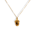 Gold dainty acorn necklace on gold chain.