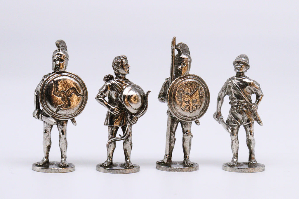 Four Greek Warrior Figurines, silver with orange-ish red reflection, on white background