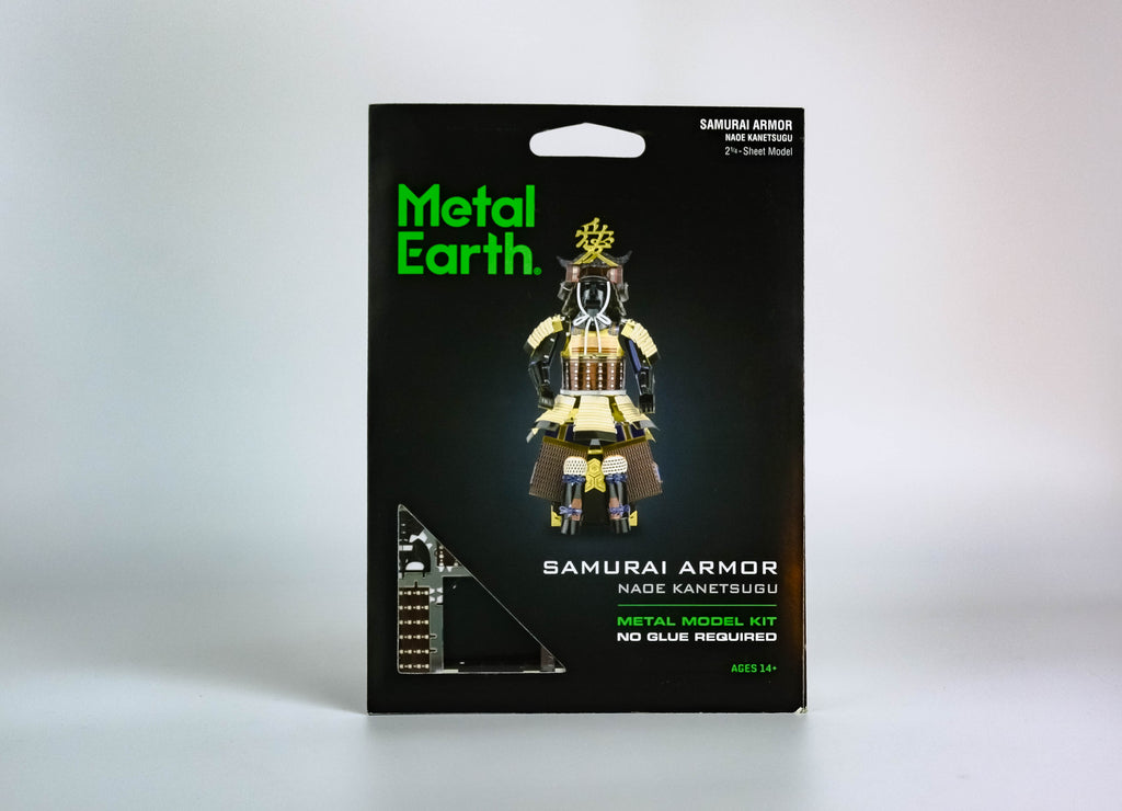 Black activity kit with green text "metal earth," black, gold, silver, burgundy Samurai armor in center. On white background. 
