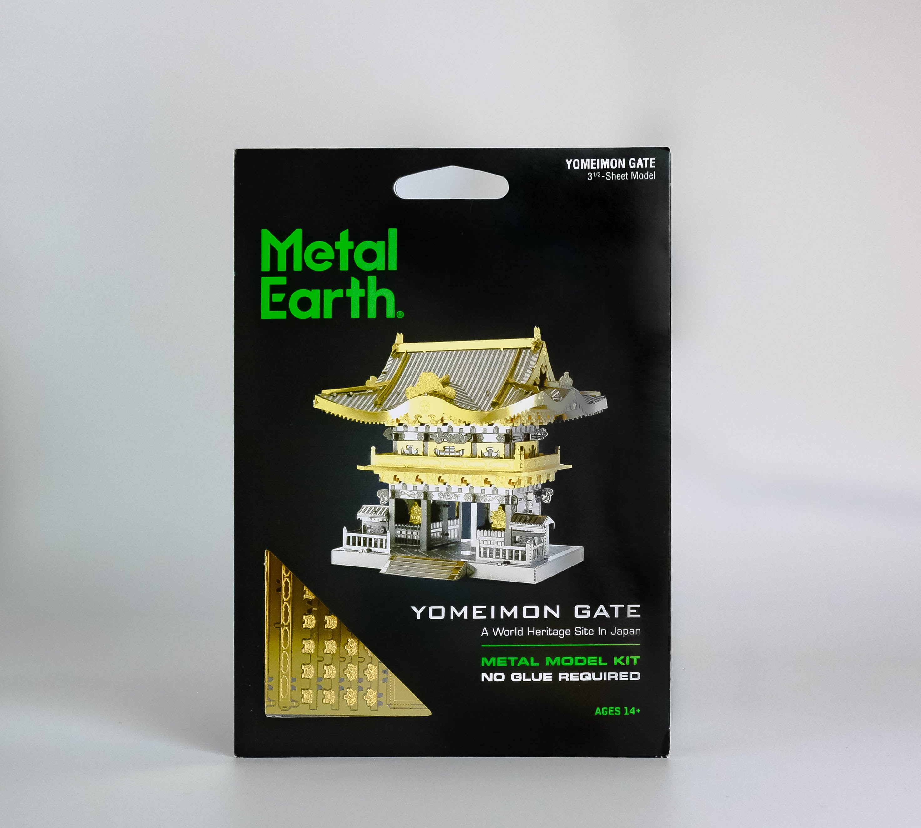 Black activity kit with green text "metal earth," silver and gold Yomeimon gate in center. On white background. 